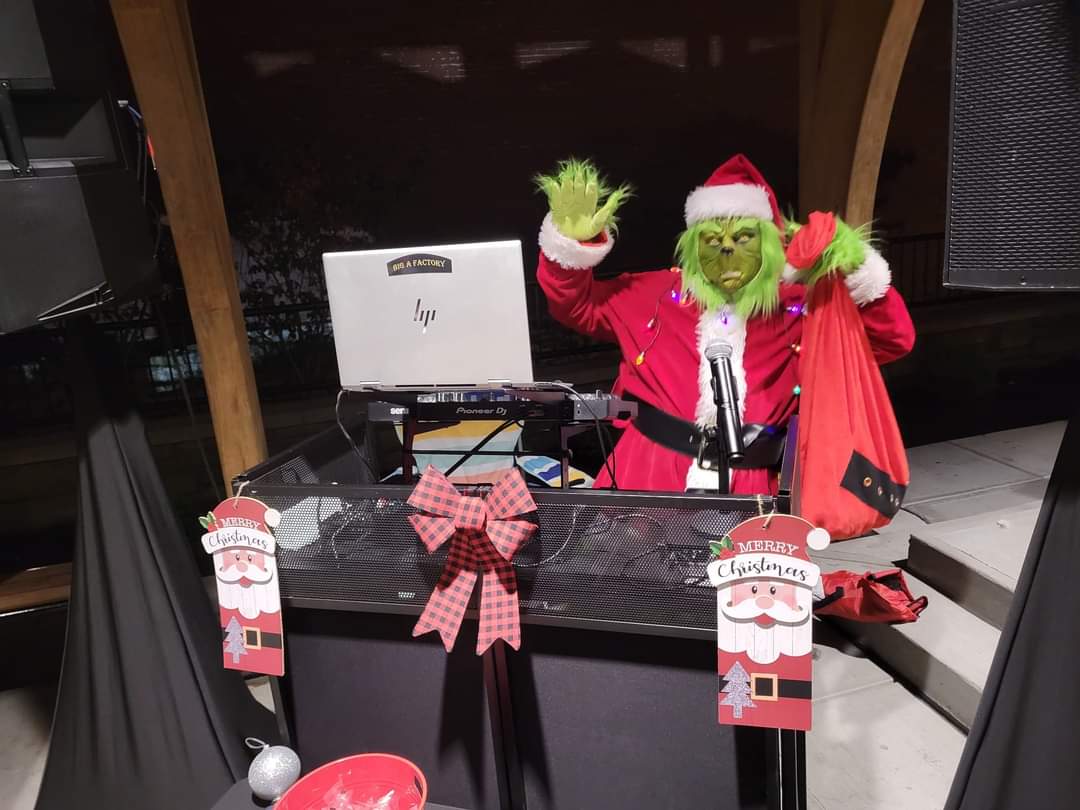 Mr. Grinch entertaining guests at a holiday event